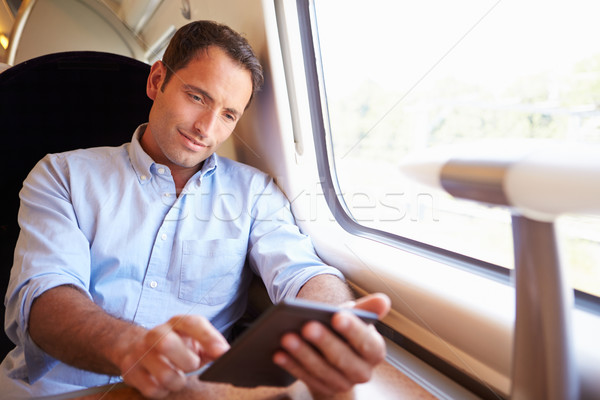 Man Reading E Book On Train Stock photo © monkey_business