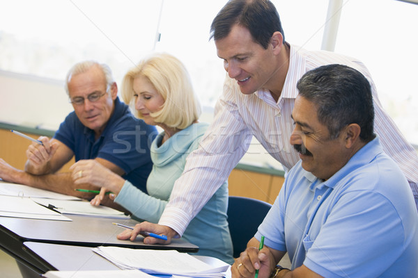 Teacher assisting mature student in class Stock photo © monkey_business