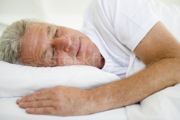 Man lying in bed sleeping Stock photo © monkey_business