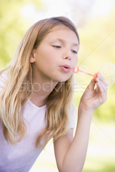 Young girl blowing bubbles outdoors Stock photo © monkey_business