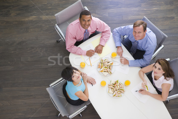 Quatro sala de reuniões tabela sanduíches sorridente Foto stock © monkey_business