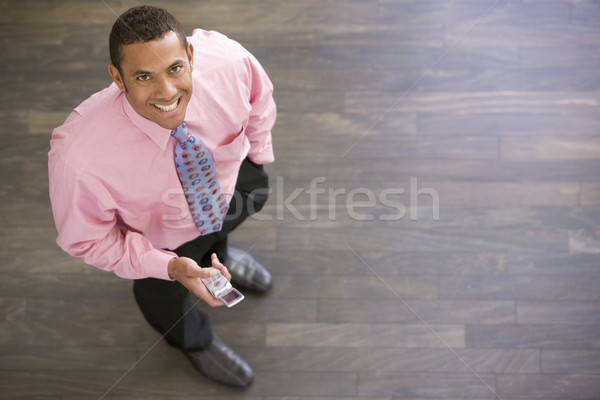 Empresário em pé celular sorridente homem Foto stock © monkey_business