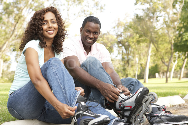 Couple Putting On In Line Skates In Park Stock photo © monkey_business
