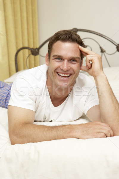 Stock photo: Man Relaxing On Bed At Home
