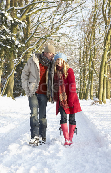 Stock photo: Couple Walking Through Snowy Woodland