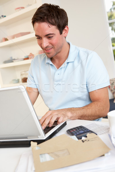 Young man working with laptop computer Stock photo © monkey_business