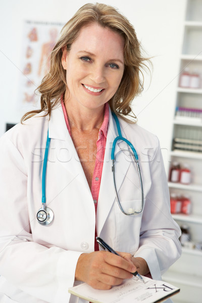 Mid age female doctor writing prescription Stock photo © monkey_business