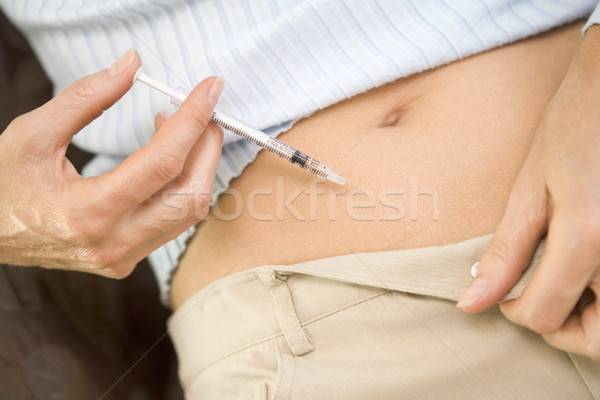 Woman injecting drugs to prepare for IVF treatment Stock photo © monkey_business