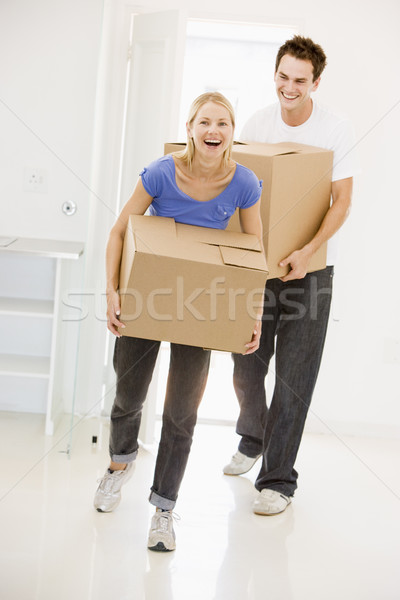 Couple with boxes moving into new home smiling Stock photo © monkey_business