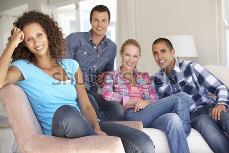 Groupe amis regarder photos appareil photo numérique maison [[stock_photo]] © monkey_business