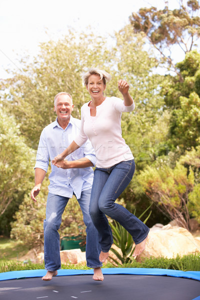 Couple Jumping On Trampoline In Garden Stock photo © monkey_business
