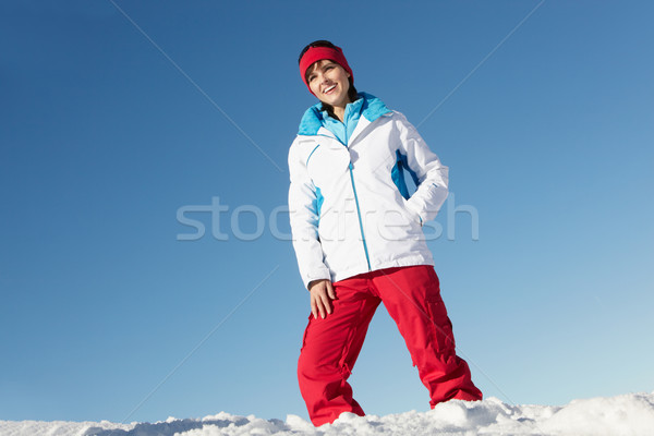 Woman Standing In Snow Wearing Warm Clothes On Ski Holiday In Mo Stock photo © monkey_business