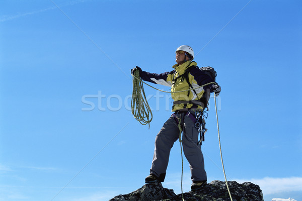 Stock photo: Mountaineer on top of mountain summit