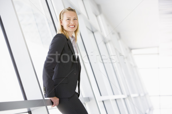 Businesswoman standing in corridor smiling Stock photo © monkey_business