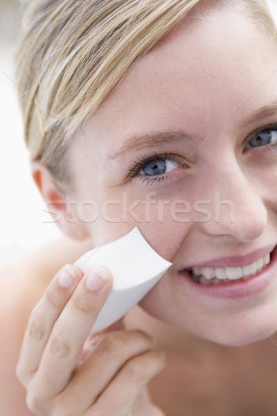 Woman removing makeup smiling Stock photo © monkey_business