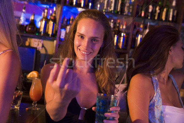 Young woman in nightclub beckoning to camera Stock photo © monkey_business