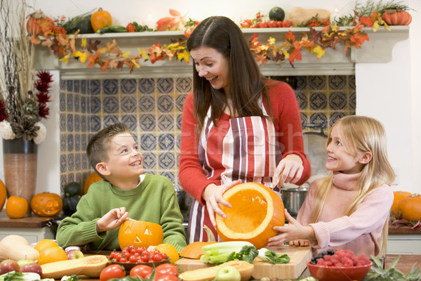 Mother and two children carving jack o lanterns on Halloween and Stock photo © monkey_business