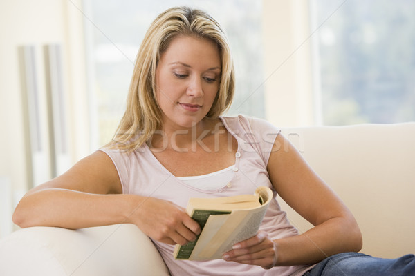 Stock photo: Woman in living room reading book