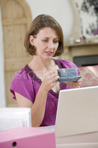 Woman drinking coffee at her desk Stock photo © monkey_business