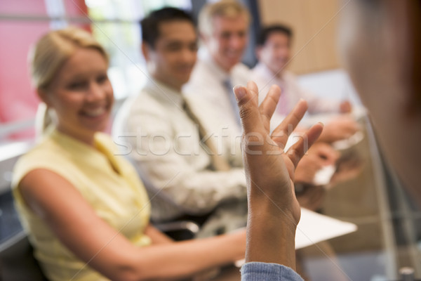 Five businesspeople at boardroom table with focus on businessman Stock photo © monkey_business