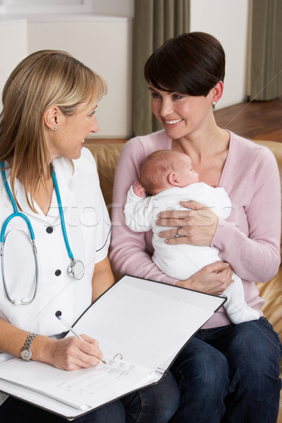 Mother With Newborn Baby Talking With Health Visitor At Home Stock photo © monkey_business