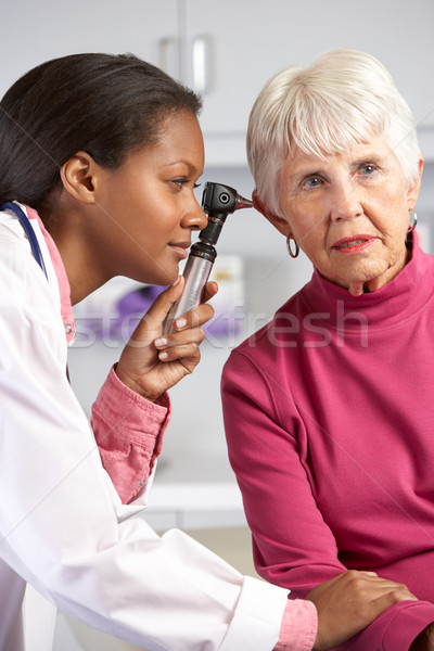 Doctor Examining Senior Female Patient's Ears Stock photo © monkey_business