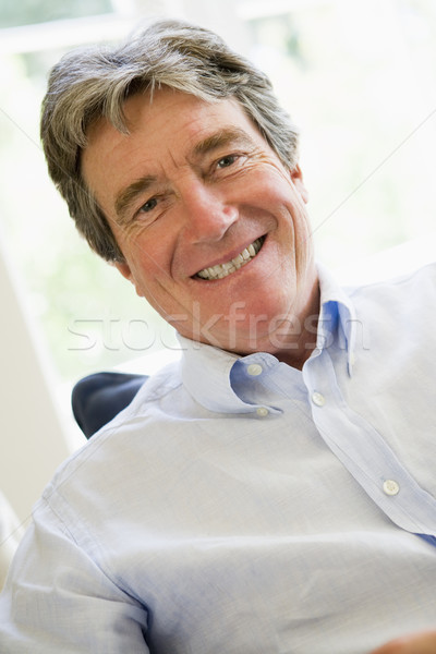 Stock photo: Man in living room smiling