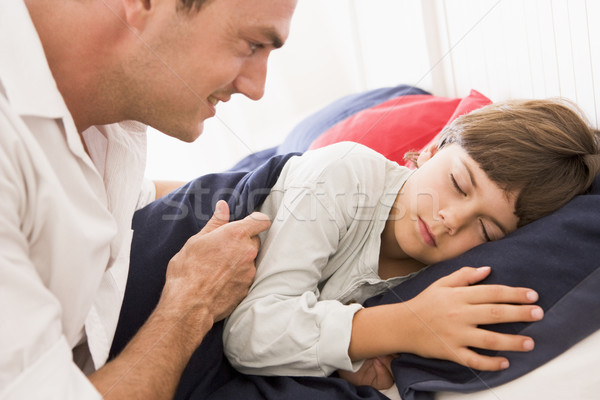 Man waking young boy in bed smiling Stock photo © monkey_business