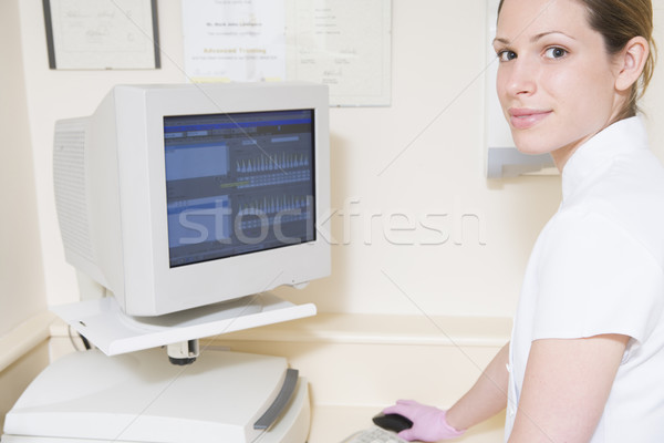 Dental assistant using computer smiling Stock photo © monkey_business