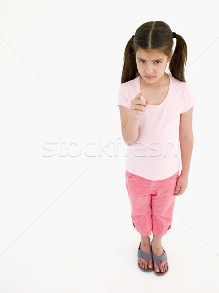 Young girl pointing and frowning Stock photo © monkey_business
