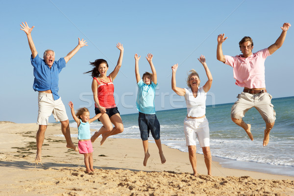 Portrait Of Three Generation Family On Beach Holiday Jumping In  Stock photo © monkey_business