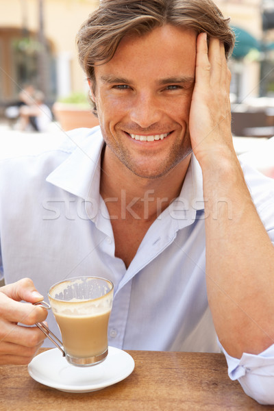 Young Man Enjoying Cup Of Coffee In Caf Stock photo © monkey_business