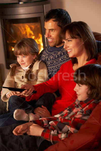 Family Relaxing Watching TV By Cosy Log Fire Stock photo © monkey_business