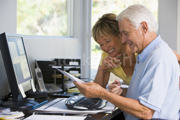 Couple bureau à domicile ordinateur paperasserie souriant homme [[stock_photo]] © monkey_business