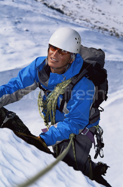 Fiatalember hegymászás csúcs mászik szín kint Stock fotó © monkey_business