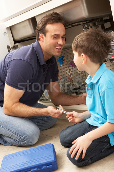 Son Helping Father To Mend Sink In Kitchen Stock photo © monkey_business