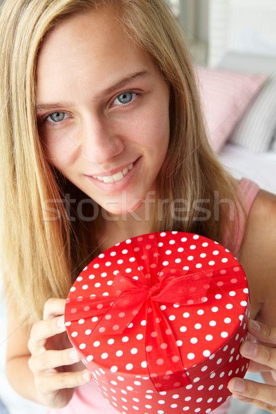 Teenage girl holding gift box Stock photo © monkey_business