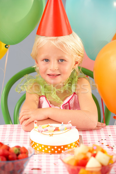 Stock photo: Young girl with birthday cake at party