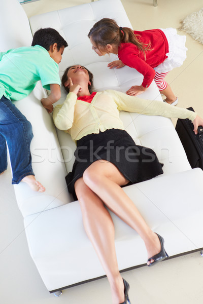 Children Welcoming Tired Mother Returning From Work Stock photo © monkey_business