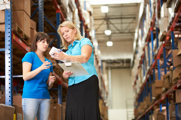 Businesswoman And Female Worker In Distribution Warehouse Stock photo © monkey_business
