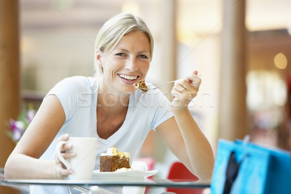 Stock photo: Woman Eating A Piece Of Cake At The Mall