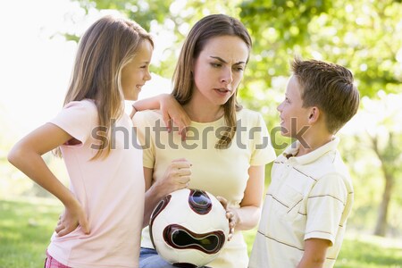 Woman and two young children outdoors holding volleyball and smi Stock photo © monkey_business