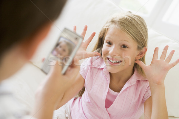 Young boy taking picture of smiling young girl with camera phone Stock photo © monkey_business