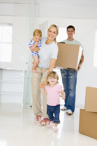 Family with box moving into new home smiling Stock photo © monkey_business
