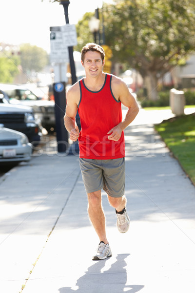 Homme courir rue de la ville soleil rue bâtiments [[stock_photo]] © monkey_business