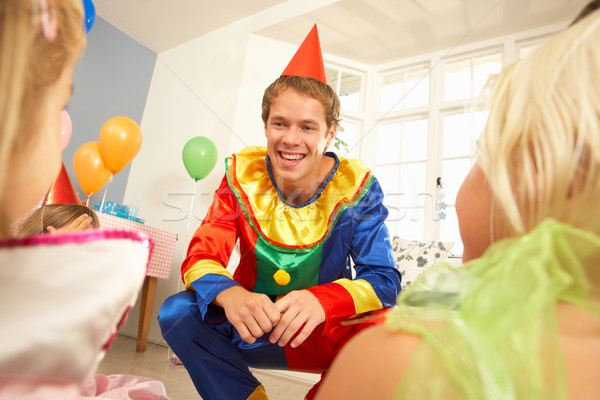 Stock photo: Clown entertaining children at party