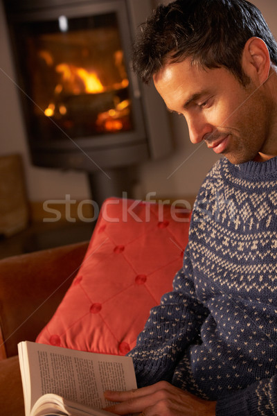 Középkorú férfi megnyugtató könyv kényelmes tűz férfi Stock fotó © monkey_business