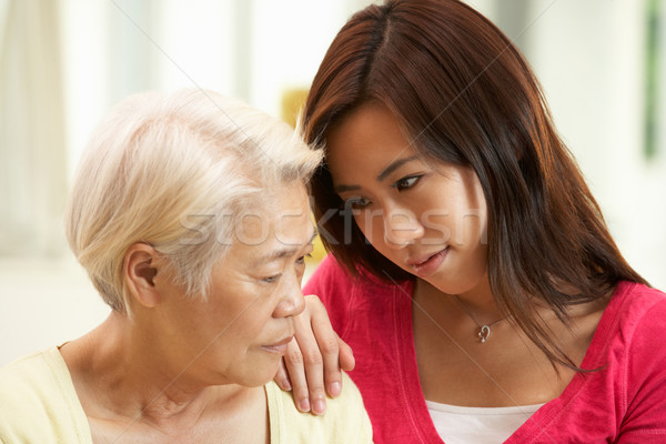 Unhappy Chinese Mother Being Comforted By Adult Daughter Stock photo © monkey_business