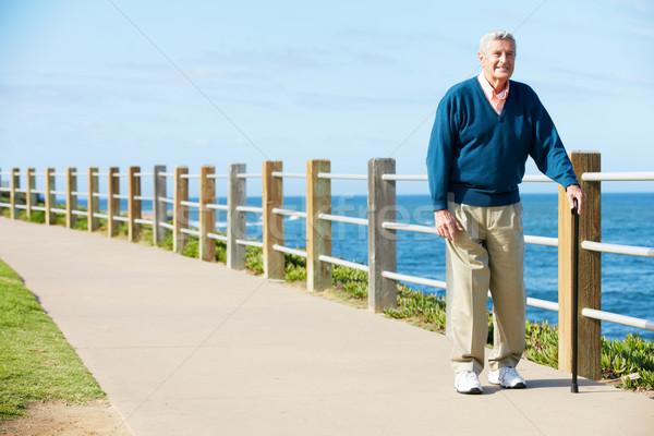 Senior Man Walking Along Path By The Sea Stock photo © monkey_business