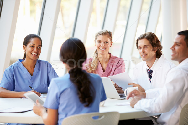 Medical Team Meeting Around Table In Modern Hospital Stock photo © monkey_business